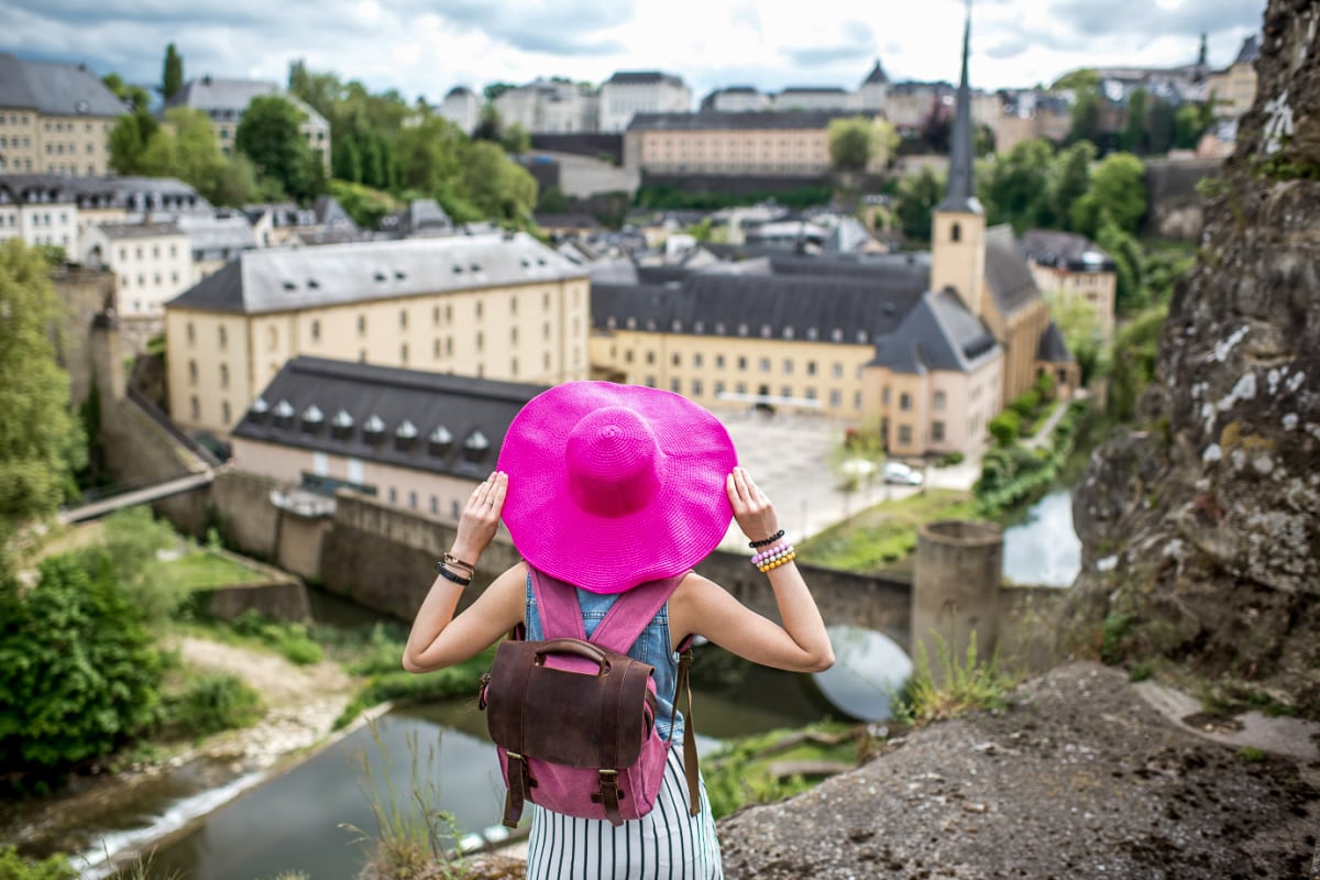 Woman looking over Luxembourg City with a pink hat on
